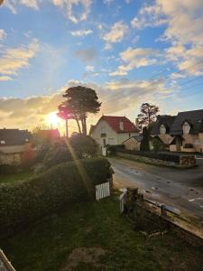 a view of a residential street with the sun setting at Ti a mor in Carnac