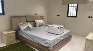 a bedroom with a large bed in a room at شاليه الكوثر in Al Baha