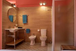a bathroom with a toilet and a sink and a mirror at Il club degli scacchi in San Lorenzo del Vallo