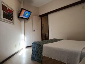 a bedroom with a bed and a tv on the wall at Boulevard Express in Belo Horizonte +37 photos