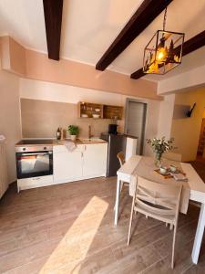 a kitchen with a table and a dining room at Yes I Know My Room - La Rua in Castel di Sangro