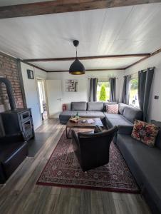 a living room with a couch and a table at Hindås stuga in Hindås