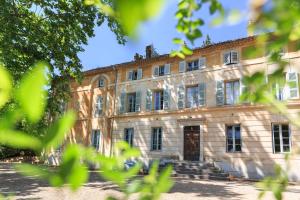 an old stone building with stairs in front of it at Chateau de Saint Martin in Taradeau