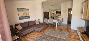 a living room with a couch and a dining room at Big Apartments in Grebaštica