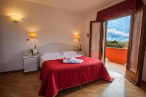 Postel nebo postele na pokoji v ubytování Hotel Le Rotonde