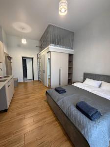 a bedroom with a large bed and a wooden floor at Green door in Kolomiya