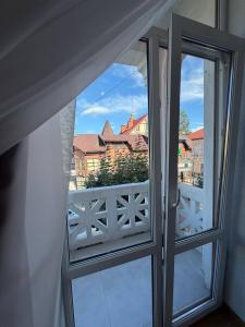 an open window with a view of a balcony at Green door in Kolomiya