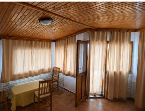 a bedroom with a bed and a table and two chairs at Атлас in Byala