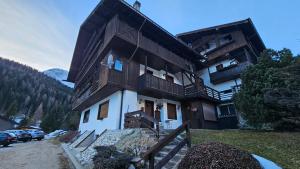 a large building with wooden balconies on a mountain at Belvedere Pecol in Mareson