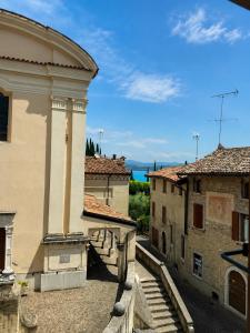 a view of an old building in a city at B&B Casa Olivia in Gardone Riviera +7 photos