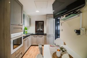a kitchen with a table and a dining room at Urška's Premium House Terme Čatež in Brežice +27 photos
