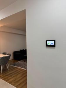 a living room with a tv on a wall at Modi Living Apartment in Skopje