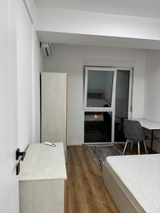 a bedroom with a bed and a desk and a table at Modi Living Apartment in Skopje +12 photos