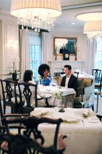 a group of people sitting at a table in a restaurant at The Hay - Adams in Washington, D.C.