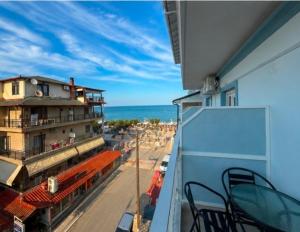 a balcony with a view of a beach and the ocean at Celeste Blu Suites & Rooms in Paralia Katerinis