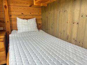 a bedroom with a bed in a wooden cabin at Fjällstugan in Sund