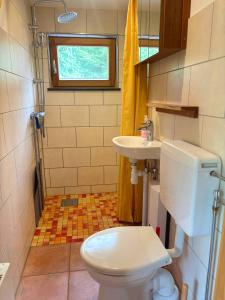 a small bathroom with a toilet and a sink at Fjällstugan in Sund +38 photos