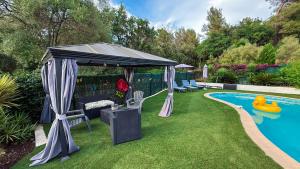 a gazebo with a pool in a backyard at Villa Caraïbes in Vence +14 photos