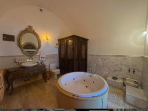 a large bathroom with a tub and a sink at Kervansaray Antique Hotel in Çeşme +66 photos