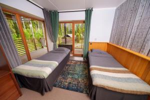 a bedroom with two beds and a balcony at Taevaskoja Holiday Center in Taevaskoja