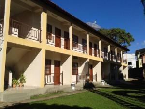 a building with balconies on the side of it at Pousada Clube Santa Cruz in Santa Cruz de Minas