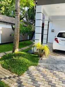 a white car parked in front of a house at Letharo Residancies in Dodanduwa +20 photos