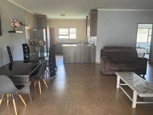 a kitchen and living room with a table and a couch at Bouleigh in Kempton Park