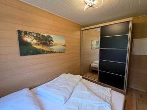a bedroom with a bed and a large mirror at Bungalow Seedorf 9 in Basedow