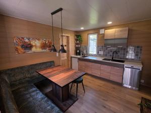 a kitchen with a wooden table in a room at Bungalow Seedorf 9 in Basedow