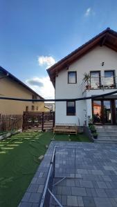 a white house with a patio and a yard at Casa A&A Stefan Livada in Livada