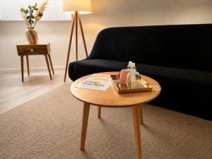 a living room with a table and a couch at Hotel zur Linde in Berghausen