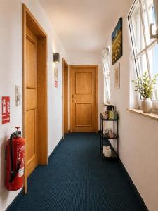 a hallway with a fire hydrant and a door at Hotel zur Linde in Berghausen