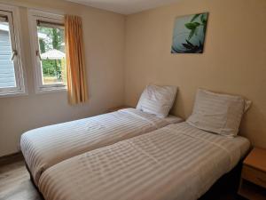 a bedroom with a large bed in a room at De Tien Heugten in Schoonloo +32 photos