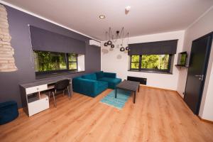 a living room with a blue couch and a table at Taevaskoja Holiday Center in Taevaskoja