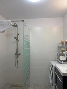 a bathroom with a glass shower and a sink at Aero Comfort Apartment in Cluj-Napoca
