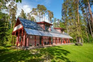 a red barn in the middle of a forest at Taevaskoja Holiday Center in Taevaskoja