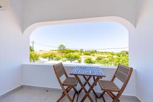 a table and two chairs on a balcony with a view at Vivenda Vilhegas in Albufeira