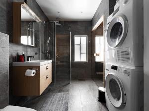 a bathroom with a shower and a washing machine at Spacious Slopeside Home with Sauna in Åre