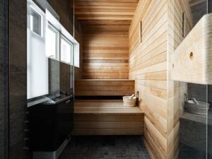 a bathroom with a sauna with wooden walls and a window at Spacious Slopeside Home with Sauna in Åre