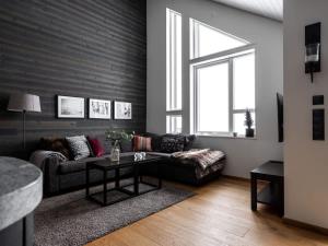 a living room with a couch and a table at Spacious Slopeside Home with Sauna in Åre +15 photos