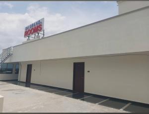 a white building with a sign on top of it at RKGRANDROOM's in Kolanukonda
