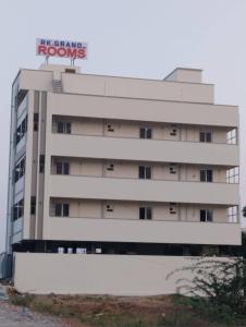 a building with a sign on top of it at RKGRANDROOM's in Kolanukonda