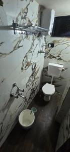 a bathroom with a sink and a toilet at Tuljapur Bhaktaniwas in Tuljapur
