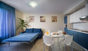 a living room with a blue couch and a table at Continental Resort in Tirrenia