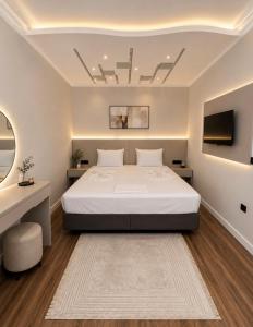 a bedroom with a large bed and a tv at Kumkapı Hotel - Special Category in Istanbul