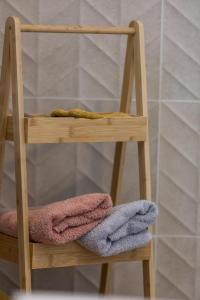a wooden chair with three towels on it at Fauceana in Orist +44 photos