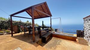 a patio with a table and a view of the ocean at Casa Maruca in Puntagorda