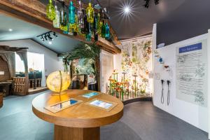 a room with a table with glass bottles on the wall at Chateau de Saint Martin in Taradeau