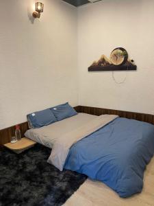 a bedroom with a bed and a clock on the wall at Hoa Rừng Homestay in Xuan An +14 photos