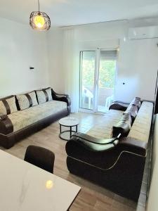 a living room with a couch and a table at Babulje in Ulcinj